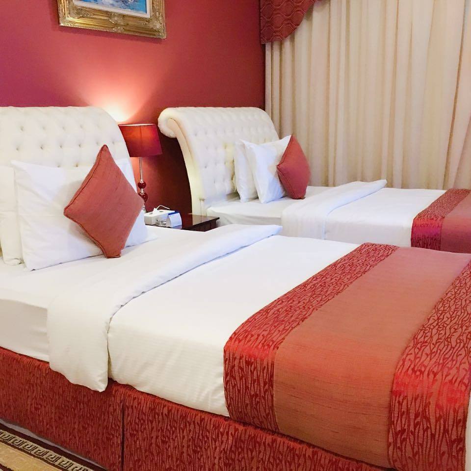Two Bedroom Suite with twin beds and a red runner
