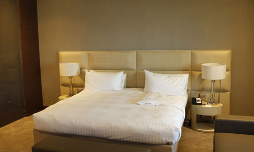 A guest room with a made bed